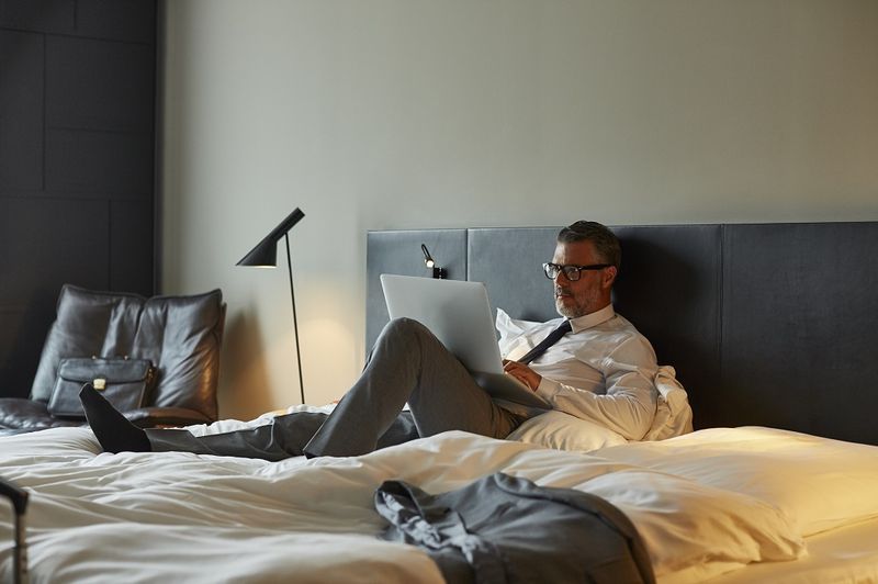 mężczyzna w łóżku z laptopem
